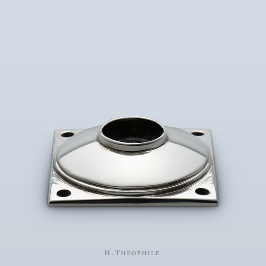 Square backplate with raised circular design and visible screws