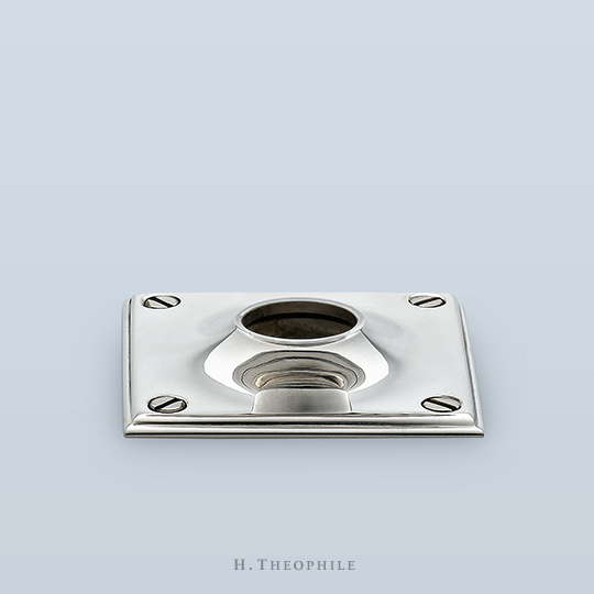 Rectangular backplate with visible screws, double-stepped edge