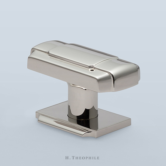 Rectangular knob with buckle motif