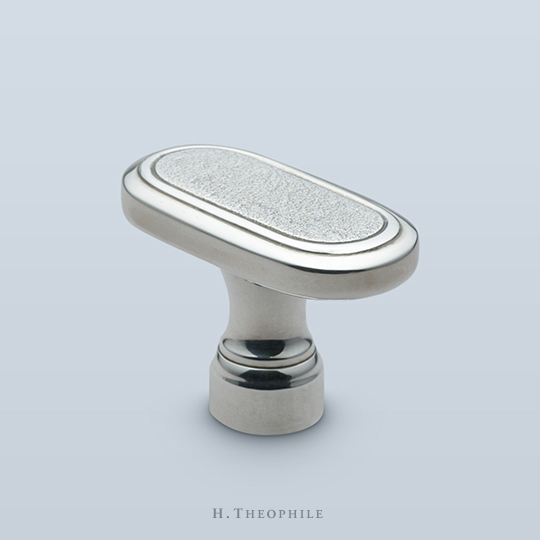 Pill-shaped knob with textured center face