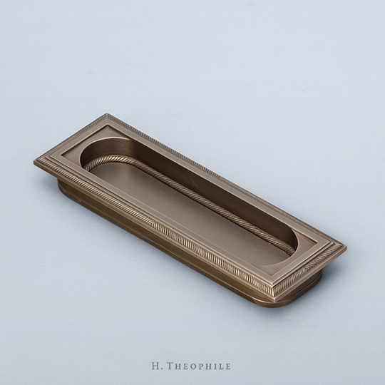 Recessed pull with stepped edge and racetrack window, knurling on frame and window