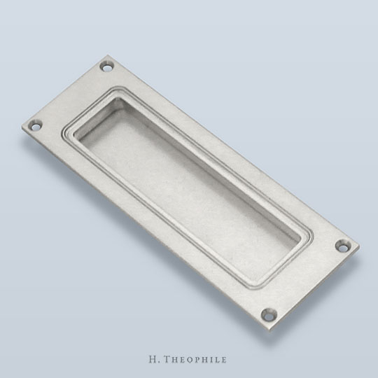Recessed pull with inner edge detail and visible screws