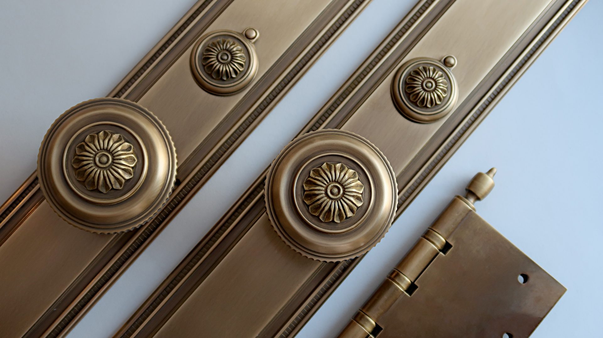 Floral decorative entry door hardware in medium antique brass finish