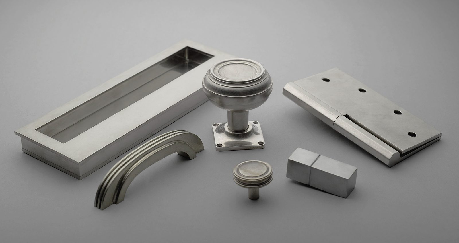 A ensemble of Art Deco door hardware with stepped detailing by H. Theophile. Shown in polished nickel finishes.