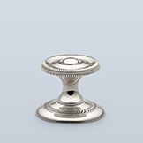 Cabinet pull with raised center and side knurling, 1-3/16" D