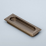 Recessed pull with stepped edge and racetrack window, knurling on frame and window